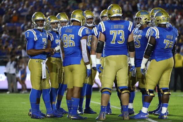 PASADENA, CA - OCTOBER 20:  Quarterback Dorian Thompson-Robinson #7 of the UCLA Bruins looks to the sideline during a huddle in the first half of the NCAA college football game against the Arizona Wildcats at the Rose Bowl on October 20, 2018 in Pasadena, California.  (Photo by Victor Decolongon/Getty Images)