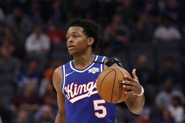 Sacramento Kings guard De'Aaron Fox dribbles down court during the second half of an NBA basketball game against the Philadelphia 76ers in Sacramento, Calif., Thursday, March 5, 2020. The 76ers won 125-108. (AP Photo/Rich Pedroncelli)