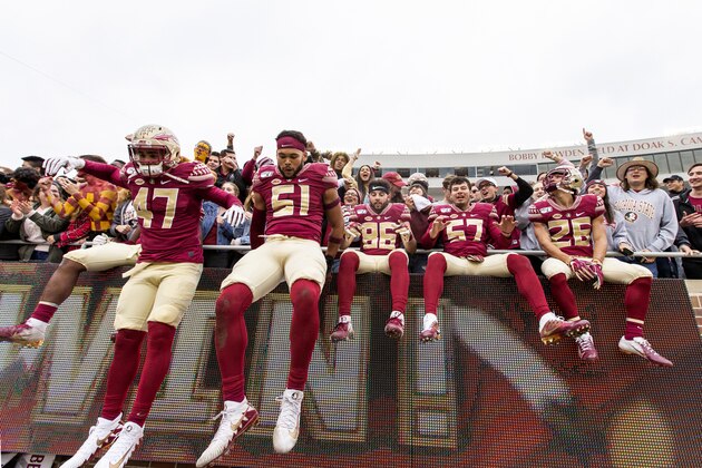 Florida State players dismount the wall after celebrating with their fans after defeating against Alabama State 49-12 in an NCAA college football game in Tallahassee, Fla., Saturday, Nov. 16, 2019. (AP Photo/Mark Wallheiser)