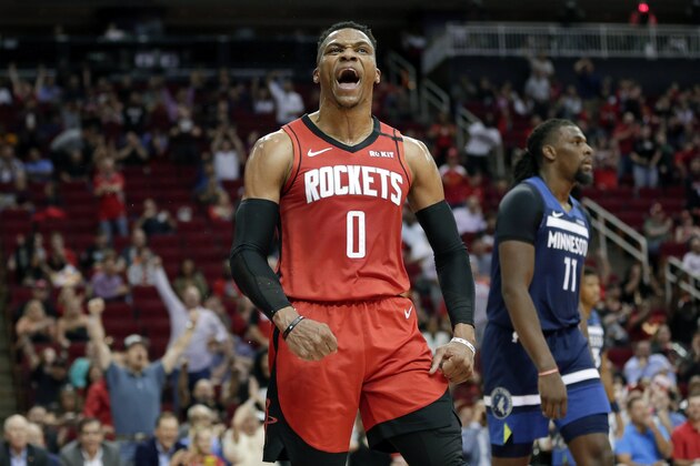 Houston Rockets guard Russell Westbrook (0) reacts after a dunk, next to Minnesota Timberwolves center Naz Reid (11) during the second half of an NBA basketball game Tuesday, March 10, 2020, in Houston. (AP Photo/Michael Wyke)