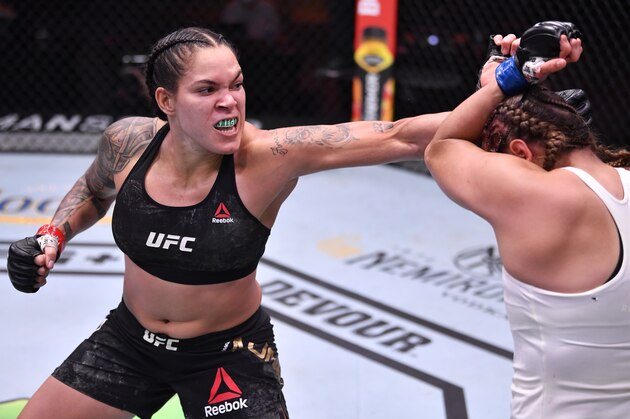 LAS VEGAS, NEVADA - JUNE 06: In this handout provided by UFC, (L-R) Amanda Nunes of Brazil punches Felicia Spencer of Canada in their UFC featherweight championship bout during the UFC 250 event at UFC APEX on June 06, 2020 in Las Vegas, Nevada. (Photo by Jeff Bottari/Zuffa LLC via Getty Images)