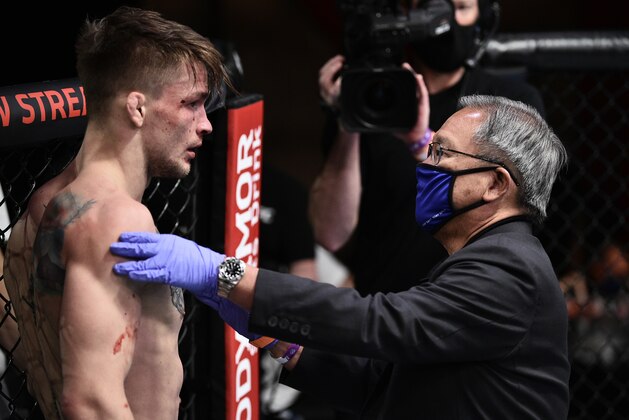 LAS VEGAS, NEVADA - JUNE 20: Max Rohskopf is checked by a doctor in his lightweight bout against Austin Hubbard during the UFC Fight Night event  at UFC APEX on June 20, 2020 in Las Vegas, Nevada. (Photo by Chris Unger/Zuffa LLC)