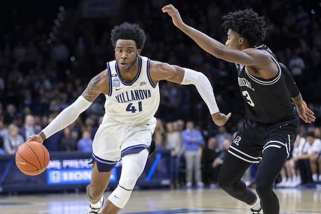 Villanova forward Saddiq Bey (41) moves around Providence guard David Duke (3) during the first half of an NCAA college basketball game, Saturday, Feb. 29, 2020, in Philadelphia, Pa. (AP Photo/Laurence Kesterson)