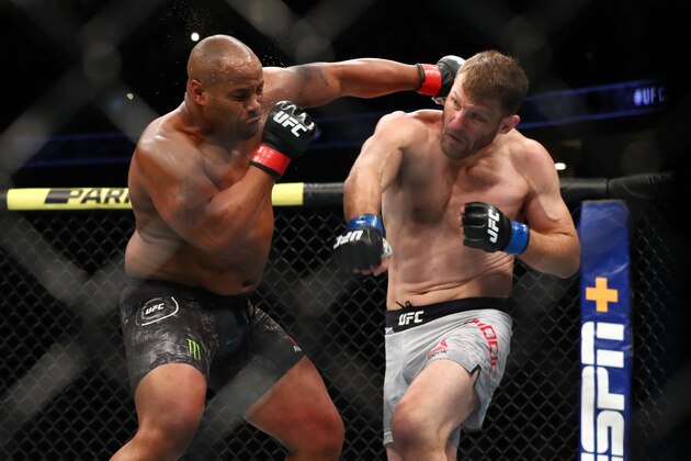 ANAHEIM, CALIFORNIA - AUGUST 17:  Daniel Cormier throws a punch at Stipe Miocic in the first round during their UFC Heavyweight Title Bout at UFC 241 at Honda Center on August 17, 2019 in Anaheim, California. (Photo by Joe Scarnici/Getty Images)
