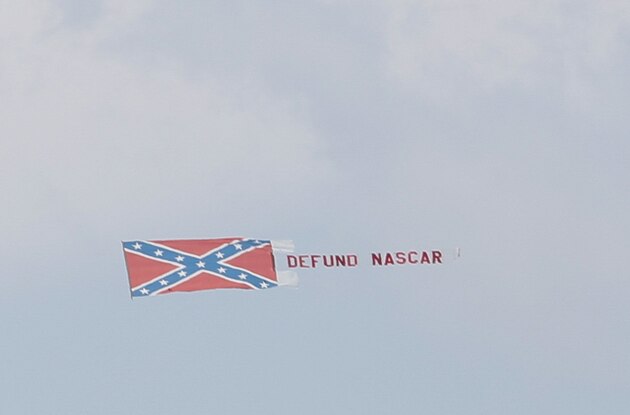 A plane trails a banner proclaiming Defund NASCAR near Talladega Superspeedway prior to a NASCAR Cup Series auto race in Talladega Ala., Sunday, June 21, 2020. (AP Photo/John Bazemore)