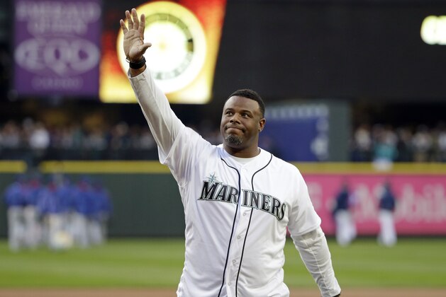 Former Seattle Mariners outfielder Ken Griffey Jr. waves to fans after being introduced before a baseball game against the Texas Rangers Friday, April 14, 2017, in Seattle. (AP Photo/Elaine Thompson)
