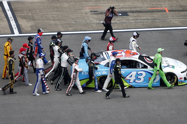 TALLADEGA, ALABAMA - JUNE 22: NASCAR drivers push the #43 Victory Junction Chevrolet, driven by Bubba Wallace, to the front of the grid as a sign of solidarity with the driver prior to the NASCAR Cup Series GEICO 500 at Talladega Superspeedway on June 22, 2020 in Talladega, Alabama. A noose was found in the garage stall of NASCAR driver Bubba Wallace at Talladega Superspeedway a week after the organization banned the Confederate flag at its facilities. (Photo by Brian Lawdermilk/Getty Images) TALLADEGA, ALABAMA - JUNE 22: NASCAR drivers push the #43 Victory Junction Chevrolet, driven by Bubba Wallace, to the front of the grid as a sign of solidarity with the driver prior to the NASCAR Cup Series GEICO 500 at Talladega Superspeedway on June 22, 2020 in Talladega, Alabama. A noose was found in the garage stall of NASCAR driver Bubba Wallace at Talladega Superspeedway a week after the organization banned the Confederate flag at its facilities. (Photo by Brian Lawdermilk/Getty Images)