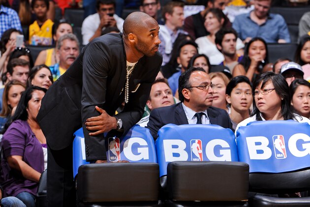 LOS ANGELES, CA - APRIL 28: Kobe Bryant #24 of the Los Angeles Lakers, sidelined due to an injury, looks on from the bench as his teammates play the San Antonio Spurs in Game Four of the Western Conference Quarterfinals during the 2013 NBA Playoffs at Staples Center on April 28, 2013 in Los Angeles, California. NOTE TO USER: User expressly acknowledges and agrees that, by downloading and/or using this Photograph, user is consenting to the terms and conditions of the Getty Images License Agreement. Mandatory Copyright Notice: Copyright 2013 NBAE (Photo by Andrew D. Bernstein/NBAE via Getty Images)