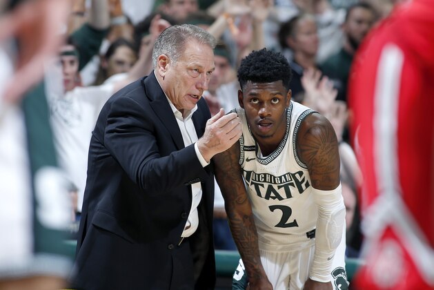 Michigan State coach Tom Izzo, left, talks with Rocket Watts during the second half of an NCAA college basketball game against Ohio State, Sunday, March 8, 2020, in East Lansing, Mich. (AP Photo/Al Goldis)