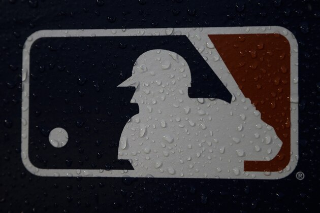 A rain-covered logo is seen at Fenway Park before Game 1 of the World Series baseball game between the Boston Red Sox and the Los Angeles Dodgers Tuesday, Oct. 23, 2018, in Boston. (AP Photo/Matt Slocum)