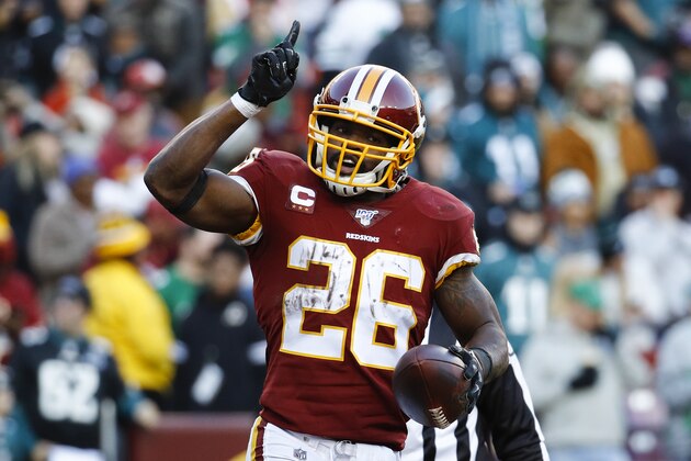 Washington Redskins running back Adrian Peterson (26) points upwards after scoring a touchdown against the Philadelphia Eagles in the second half of an NFL football game, Sunday, Dec. 15, 2019, in Landover, Md. (AP Photo/Patrick Semansky)