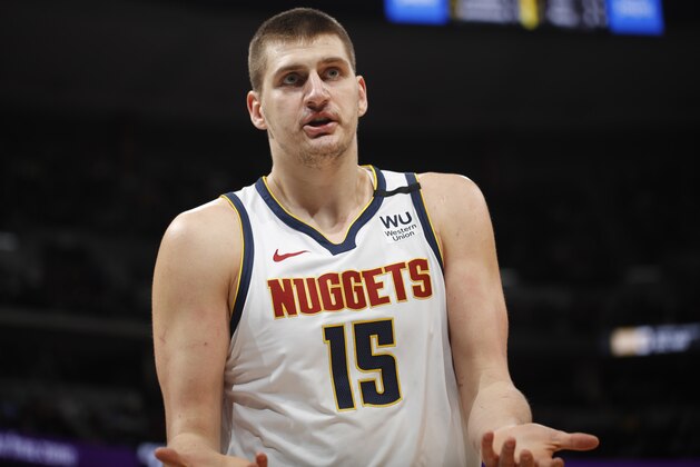 Denver Nuggets center Nikola Jokic argues after being called for a foul against the Milwaukee Bucks in the first half of an NBA basketball game Monday, March 9, 2020, in Denver. (AP Photo/David Zalubowski)