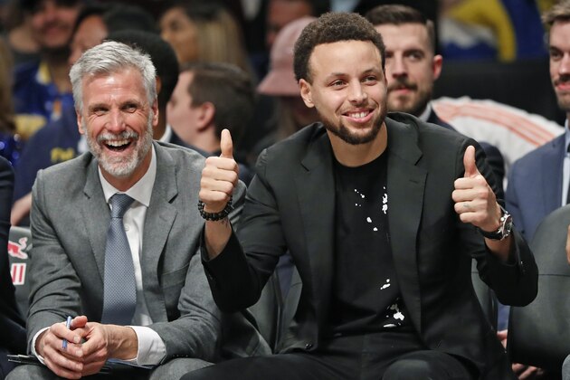ADDS NAME OF ASSISTANT COACH - Golden State Warriors Stephen Curry, right, gives a thumbs-up to a Brooklyn Nets fan known as