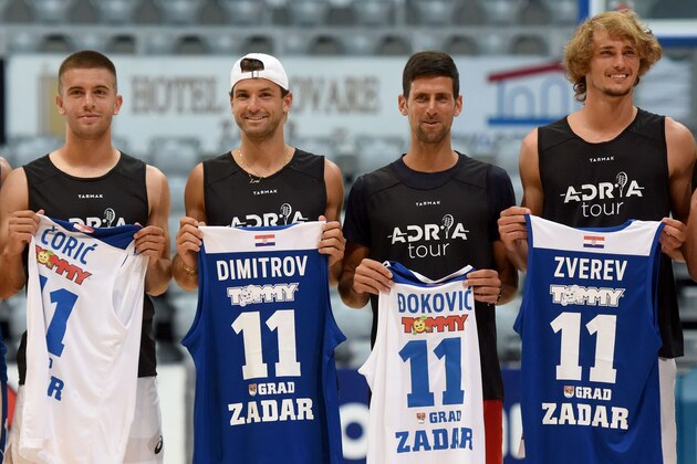 This photograph taken on June 18, 2020, shows (L/R):Croatia's Borna Coric, Bulgaria's Grigor Dimitrov, Serbia's Novak Djokovic and Germany's Alexander Zverev, tennis players as they pose for a group photograph ahead of an exhibition basketball match in Zadar. - Croatia's Borna Coric announced on June 22, 2020, that he has become the second player to test positive for coronavirus after taking part in an exhibition tournament in Croatia featuring world number one Novak Djokovic. This photograph taken on June 18, 2020, shows (L/R):Croatia's Borna Coric, Bulgaria's Grigor Dimitrov, Serbia's Novak Djokovic and Germany's Alexander Zverev, tennis players as they pose for a group photograph ahead of an exhibition basketball match in Zadar. - Croatia's Borna Coric announced on June 22, 2020, that he has become the second player to test positive for coronavirus after taking part in an exhibition tournament in Croatia featuring world number one Novak Djokovic.
