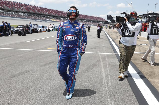 Driver Bubba Wallace walks through the pits prior to the start of the NASCAR Cup Series at the Talladega Superspeedway in Talladega, Ala., Monday, June 22, 2020. (AP Photo/John Bazemore)