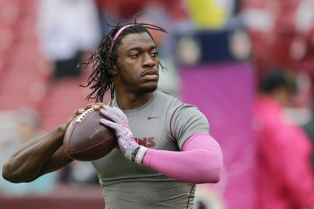 Wearing pink in support of breast cancer awareness Washington Redskins quarterback Robert Griffin III (10) warms up before an NFL football game against the Philadelphia Eagles in Landover, Md., Sunday, Oct. 4, 2015. (AP Photo/Mark Tenally)