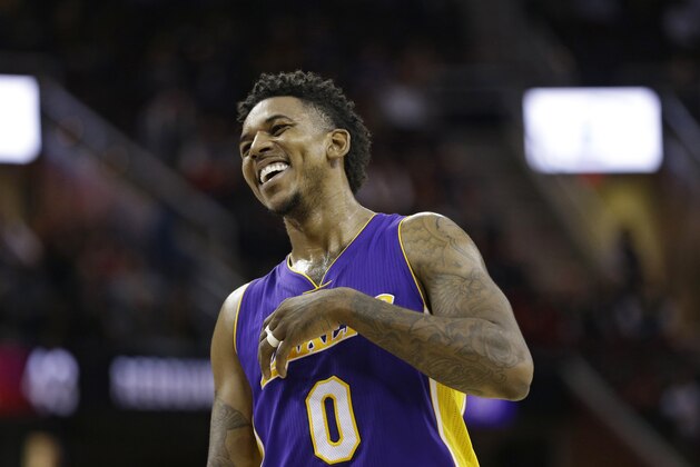 Los Angeles Lakers' Nick Young (0) laughs during a timeout in the second half of an NBA basketball game against the Cleveland Cavaliers, Saturday, Dec. 17, 2016, in Cleveland. (AP Photo/Tony Dejak)