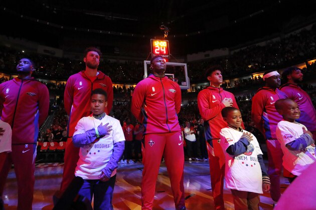 New Orleans Pelicans forward Zion Williamson, center, stands with teammates for the National Anthem before an NBA basketball game in New Orleans, Wednesday, Jan. 22, 2020. (AP Photo/Gerald Herbert)