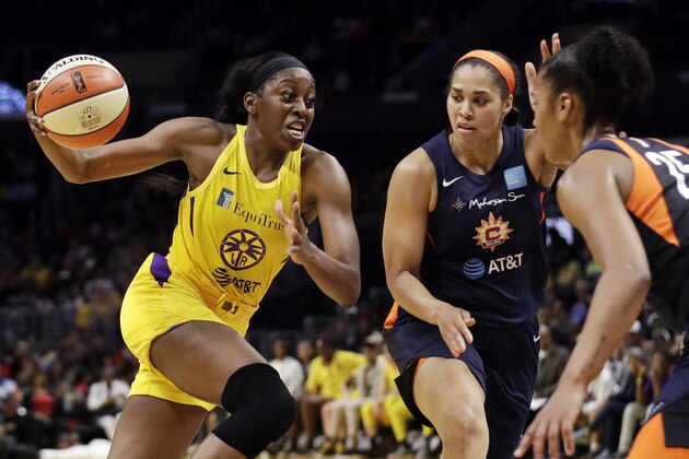 FILE - In this May 31, 2019, file photo, Los Angeles Sparks' Chiney Ogwumike, left, dribbles next to Connecticut Sun's Brionna Jones, center, and Alyssa Thomas, right, during the second half of a WNBA basketball game in Los Angeles. Ogwumike was drafted by the Sun with the No. 1 pick in 2014.  (AP Photo/Marcio Jose Sanchez, File)