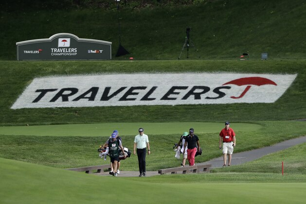 Mackenzie Hughes, center, of Canada, and Fabian Gomez, second from right, of Argentina, walk toward the 15th green during the second round of the Travelers Championship golf tournament at TPC River Highlands, Friday, June 26, 2020, in Cromwell, Conn. (AP Photo/Frank Franklin II)