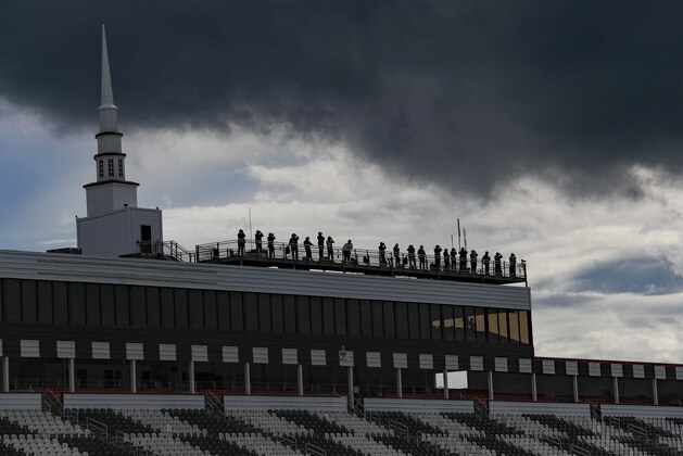 Dark clouds hover over the spotters for the drivers as the NASCAR Cup Series auto race gets under way at Pocono Raceway, Saturday, June 27, 2020, in Long Pond, Pa. (AP Photo/Matt Slocum)