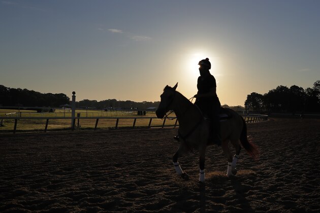 A rider works out a horse just after sunrise at Belmont Park in Elmont, N.Y., Wednesday, June 17, 2020. Tiz the Law looks every bit like the best 3-year-old in the world and is the Triple Crown favorite, even with the races being run out of their normal order. It'll take something spectacular Saturday from a watered-down field to prevent him from becoming the first New York-bred horse to win the Belmont Stakes in over 130 years. (AP Photo/Seth Wenig)