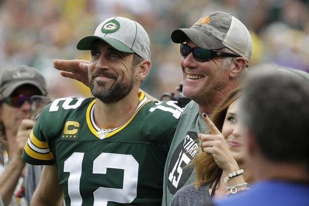 Green Bay Packers' Aaron Rodgers smiles with former quarterback Brett Favre during halftime of an NFL football game against the Minnesota Vikings Sunday, Sept. 15, 2019, in Green Bay, Wis. (AP Photo/Mike Roemer)