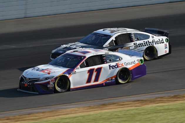 LONG POND, PENNSYLVANIA - JUNE 28: Denny Hamlin, driver of the #11 FedEx Ground Toyota, races Aric Almirola, driver of the #10 Smithfield Ford, during the NASCAR Cup Series Pocono 350 at Pocono Raceway on June 28, 2020 in Long Pond, Pennsylvania. (Photo by Jared C. Tilton/Getty Images)