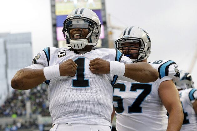 Carolina Panthers quarterback Cam Newton (1) reacts after he rushed for a touchdown in the first half of an NFL football game against the Seattle Seahawks, Sunday, Oct. 18, 2015, in Seattle. (AP Photo/Elaine Thompson)