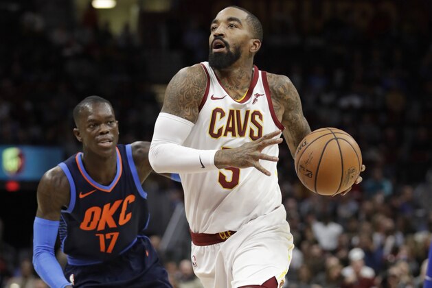 Cleveland Cavaliers' JR Smith (5) drives past Oklahoma City Thunder's Dennis Schroder (17), from Germany,in the first half of an NBA basketball game, Wednesday, Nov. 7, 2018, in Cleveland. (AP Photo/Tony Dejak)