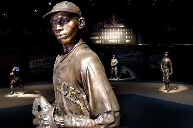 ** FILE ** In this Jan. 27, 2005 file photo,  bronze statues of Negro League greats including pitcher Satchel Paige, front, play their positions on the Field of Legends, which is the centerpiece of the Negro Leagues Baseball Museum in Kansas City, Mo. Three and a half years after the death of museum founder and ambassador Buck O'Neil, the museum is finding itself on shaky financial ground. (AP Photo/Charlie Riedel, File)