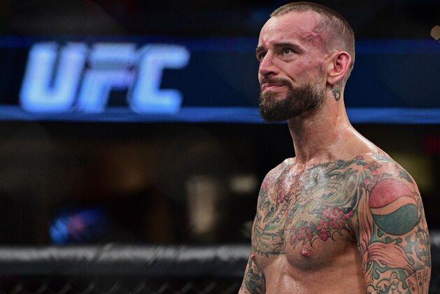 CM Punk stands in the octagon after being defeated by Mickey Gall during a welterweight bout at UFC 203 on Saturday, Sept. 10, 2016, in Cleveland.  (AP Photo/David Dermer)