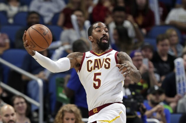 Cleveland Cavaliers' J.R. Smith passes the ball as he saves it from going out of bound during the first half of an NBA basketball game against the Orlando Magic, Monday, Nov. 5, 2018, in Orlando, Fla. (AP Photo/John Raoux)