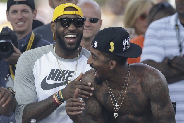 Cleveland Cavaliers' LeBron James laughs with J.R. Smith during a rally, Wednesday, June 22, 2016, in Cleveland. The Cavaliers made history by overcoming a 3-1 deficit to beat the Golden State Warriors in the NBA Finals and end the city's 52-year drought without a professional sports championship. (AP Photo/Tony Dejak)