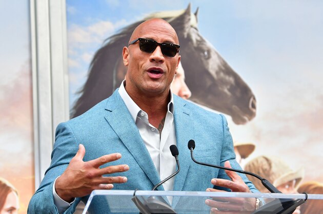 Actor Dwayne Johnson speaks at Kevin Hart's Hand and Footprints ceremony in Hollywood, California on December 10, 2019. (Photo by Frederic J. BROWN / AFP) (Photo by FREDERIC J. BROWN/AFP via Getty Images)