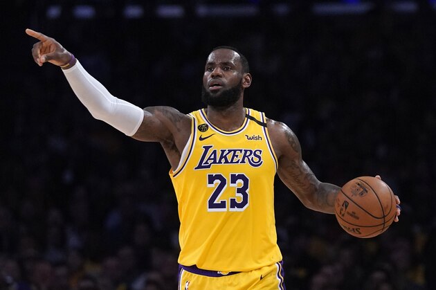 Los Angeles Lakers forward LeBron James gestures to teammates during the second half of an NBA basketball game against the Milwaukee Bucks Friday, March 6, 2020, in Los Angeles. (AP Photo/Mark J. Terrill)
