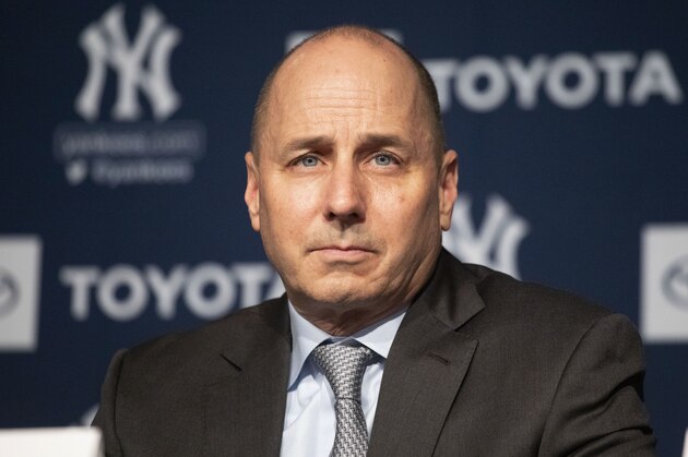 Yankees general manager Brian Cashman listens as Gerrit Cole is introduced as the newest New York Yankees player during a baseball media availability, Wednesday, Dec. 18, 2019 in New York. The pitcher agreed to a 9-year $324 million contract. (AP Photo/Mark Lennihan)