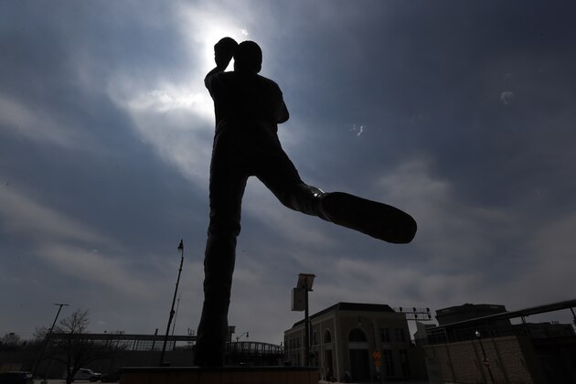 A statue outside the Joliet Slammers minor league baseball team's stadium, stands in silhouette Monday, April 6, 2020, in Joliet, Ill. (AP Photo/Charles Rex Arbogast)