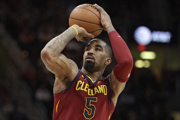 FILE - In this Jan. 28, 2018, file photo, Cleveland Cavaliers' JR Smith shoots against the Detroit Pistons in the first half of an NBA basketball game, in Cleveland.  J.R. Smith has been accused of breaking the cellphone of a fan who tried to videotape him in the middle of the night on a New York City street. Police say the Cavaliers guard turned himself in Friday, Aug. 31, 2018, to face a misdemeanor criminal mischief charge. The NBA champion was given a summons to appear in court at a later date and released. (AP Photo/Tony Dejak, File)