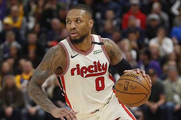 Portland Trail Blazers guard Damian Lillard (0) brings the ball up court in the first half during an NBA basketball game against the Utah Jazz Friday, Feb. 7, 2020, in Salt Lake City. (AP Photo/Rick Bowmer)