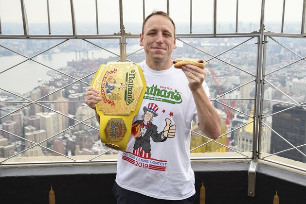 Eleven-time and defending men's champion Joey Chestnut poses on the 86th floor observation deck during the Nathan's Famous international Fourth of July hot dog eating contest weigh-in at the Empire State Building on Wednesday, July 3, 2019, in New York. (Photo by Evan Agostini/Invision/AP)