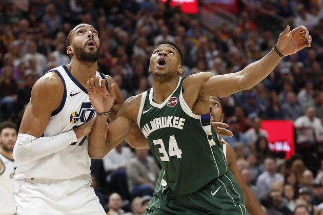 Utah Jazz center Rudy Gobert, left, and Milwaukee Bucks forward Giannis Antetokounmpo (34) look for a rebound during the first half of an NBA basketball game Friday, Nov. 8, 2019, in Salt Lake City. (AP Photo/Rick Bowmer)