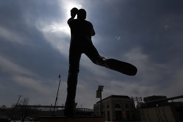 A statue outside the Joliet Slammers minor league baseball team's stadium, stands in silhouette Monday, April 6, 2020, in Joliet, Ill. (AP Photo/Charles Rex Arbogast)