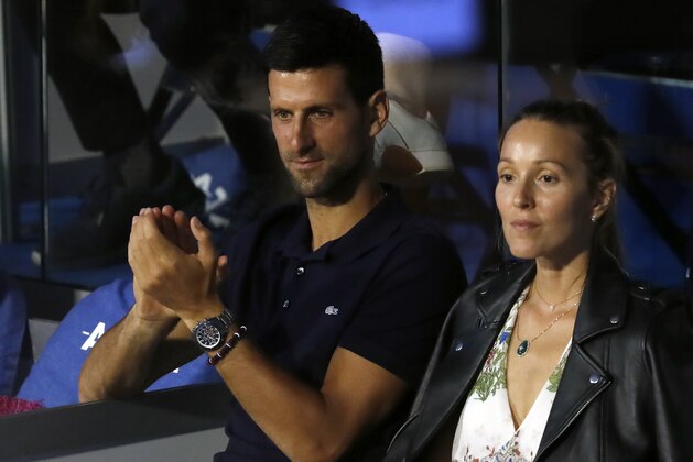 In this photo taken Sunday, June 14, 2020, Serbia's Novak Djokovic, left, with his wife Jelena watch a final match of the Adria Tour charity tournament, between Austria's Dominic Thiem and Serbia's Filip Krajinovic, in Belgrade, Serbia. Djokovic says he and his wife have tested negative for the coronavirus, his media team said Thursday July 2, 10 days after announcing they had contracted the disease. The top-ranked player tested positive for the virus after playing in an exhibition series he organized in Serbia and Croatia with zero social distancing amid the pandemic. (AP Photo/Darko Vojinovic)