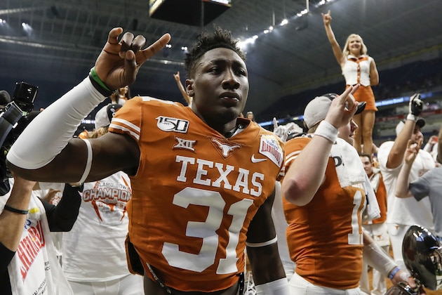 SAN ANTONIO, TX - DECEMBER 31:  DeMarvion Overshown #31 of the Texas Longhorns celebrates after the Valero Alamo Bowl game against the Utah Utes at the Alamodome on December 31, 2019 in San Antonio, Texas.  (Photo by Tim Warner/Getty Images)