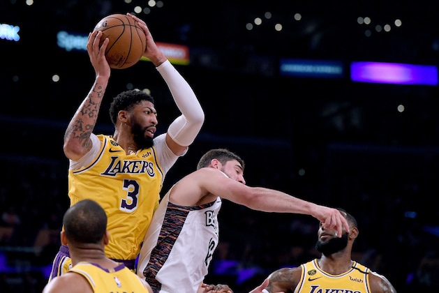 LOS ANGELES, CALIFORNIA - MARCH 10:  Anthony Davis #3 of the Los Angeles Lakers grabs a rebound away from Joe Harris #12 of the Brooklyn Nets during the first half at Staples Center on March 10, 2020 in Los Angeles, California. (Photo by Harry How/Getty Images)  NOTE TO USER: User expressly acknowledges and agrees that, by downloading and or using this photograph, User is consenting to the terms and conditions of the Getty Images License Agreement.