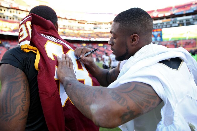 LANDOVER, MD - NOVEMBER 15: Free safety Dashon Goldson #38 of the Washington Redskins signs his jersey for another player after playing  against the New Orleans Saints at FedExField on November 15, 2015 in Landover, Maryland. The Washington Redskins won, 47-14. (Photo by Patrick Smith/Getty Images)