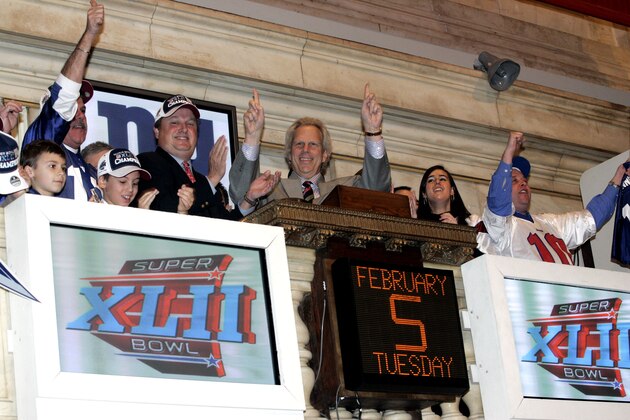 Steve Mara, center left, and Steve Tisch, center right, owners of the Giants football team smile as they ring the opening bell at the New York Stock Exchange after their victory at Super Bowl XLII, Tuesday, Feb.  5,  2008  (AP Photo/David Karp)