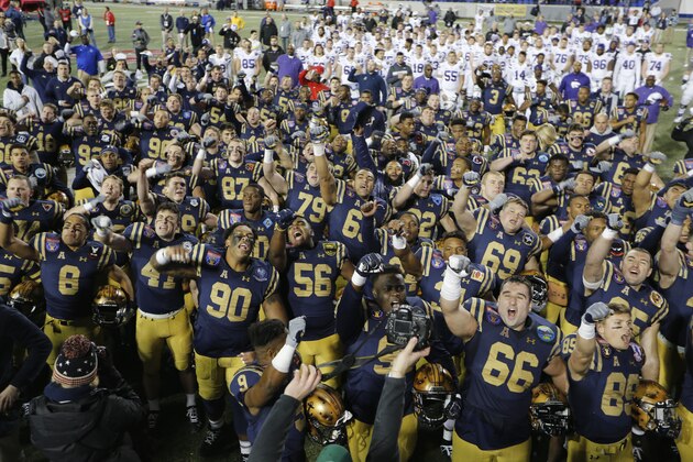 Navy players sing their alma mater after beating Kansas State in the Liberty Bowl NCAA college football game Tuesday, Dec. 31, 2019, in Memphis, Tenn. Navy won 20-17. (AP Photo/Mark Humphrey)