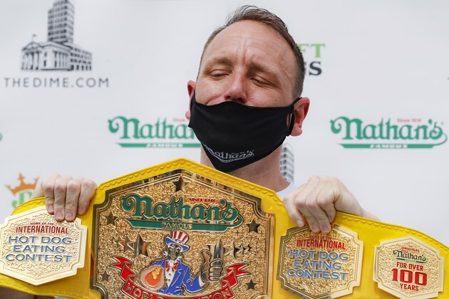 Competitive eater Joey Chestnut holds his championship belt during a weigh-in before the Nathan's Famous July Fourth hot dog eating contest, Friday, July 3, 2020, in the Brooklyn borough of New York. The weigh-in was held in a private, socially-distanced ceremony in the Williamsburg neighborhood due to COVID-19 concerns. (AP Photo/John Minchillo)